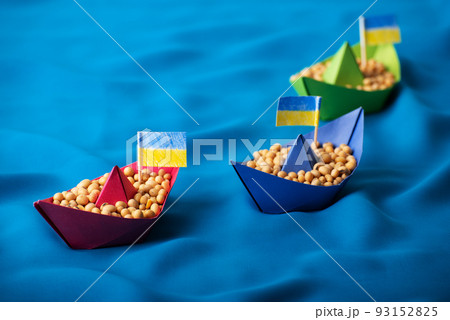 Boats with Ukrainian soybeans made of paper origami concept 93152825