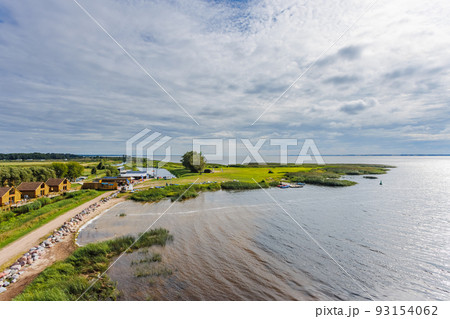 DREVERNA, LITHUANIA - AUG 08, 2022: Aerial View from the tower of Dreverna harbour. Dreverna is a village located on the Dreverna river, southwest of the village is the Curonian Lagoon. DREVERNA, LITHUANIA - AUG 08, 2022: Aerial View from the tower of Dreverna harbour. Dreverna is a village located on the Dreverna river, southwest of the village is the Curonian Lagoon. 93154062