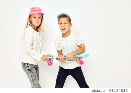 Modern teenagers posing together in caps with skateboard lifestyle childhood Modern teenagers posing together in caps with skateboard lifestyle childhood 93154886