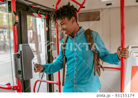 Guy holding card to reader on bus 93155174