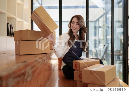 Attractive Asian SME business woman working at home office. online shopping concept Attractive Asian SME business woman working at home office. online shopping concept 93156959