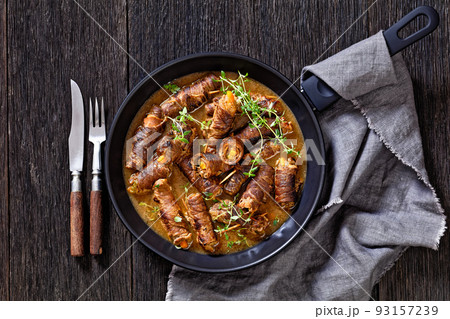 german beef rouladen in thick gravy on pan german beef rouladen in thick gravy on pan 93157239