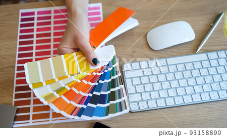 Female interior designer showing fan of colourful samples 93158890