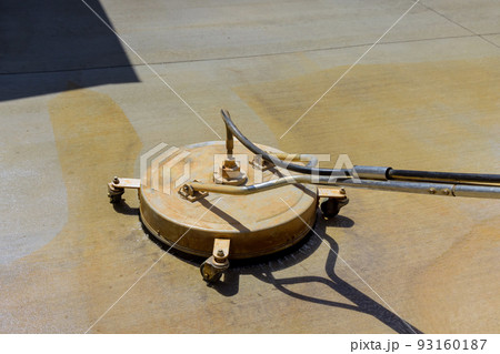 In order to clean the pavement, the worker used sweeper machines to wash it 93160187