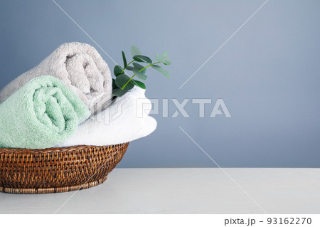 Fresh towels and eucalyptus branches on light wooden table, space for text Fresh towels and eucalyptus branches on light wooden table, space for text 93162270