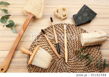 Flat lay composition with natural bamboo toothbrushes on wooden table Flat lay composition with natural bamboo toothbrushes on wooden table 93162488