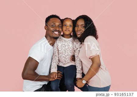Close up portrait of excited african american man, woman and girl laughing and posing 93165137