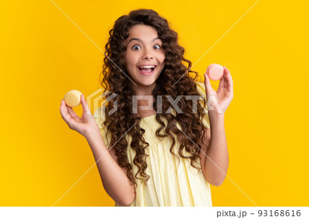 Child teen girl with dessert bakery. Teenager kid hold french macaron. Macaroon cookie. Happy teenager, positive and smiling emotions of teen girl. 93168616