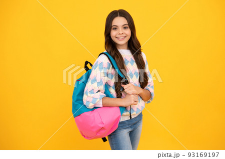 Back to school. Teenage school girl ready to learn. School children on yellow isolated background. 93169197