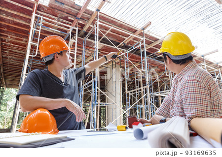 Construction concept of Engineer and Architect working at Construction Site with blue print 93169635