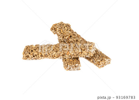 Three sweet sticks of sunflower gozinak from sunflower seeds and molasses on a white background. 93169783