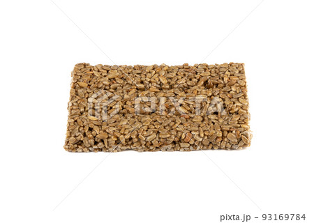 Sunflower kozinak tile from sunflower seeds and molasses on a white background. 93169784