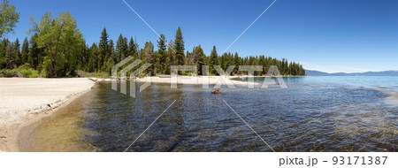 Panoramic View of Beach with Sand at Lake surrounded by Mountains and Trees. Panoramic View of Beach with Sand at Lake surrounded by Mountains and Trees. 93171387