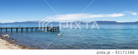 Dock on the Lake surrounded by Mountains. Summer Season. Dock on the Lake surrounded by Mountains. Summer Season. 93171388