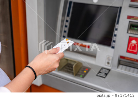 Atm machine screen. Hand holding money bank credit card. Withdraw money cash from atm. Money stack, bank credit card. 93171415