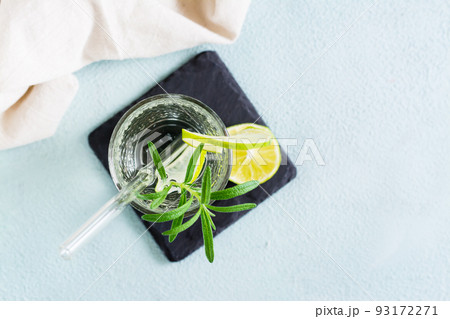 Refreshing drink mineral water with lime and rosemary in glasses with eco straw. Top view. Close-up 93172271