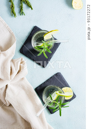 Refreshing drink water with lime and rosemary in glasses with eco straw. Top and vertical view 93172272