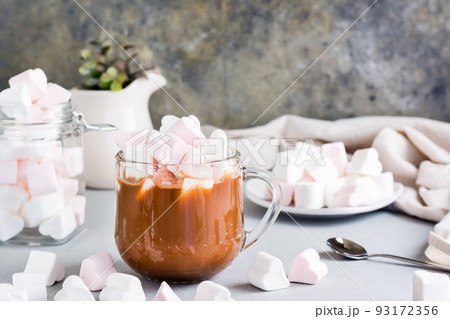 Sweet cocoa with heart-shaped marshmallows in a cup on the table Sweet cocoa with heart-shaped marshmallows in a cup on the table 93172356
