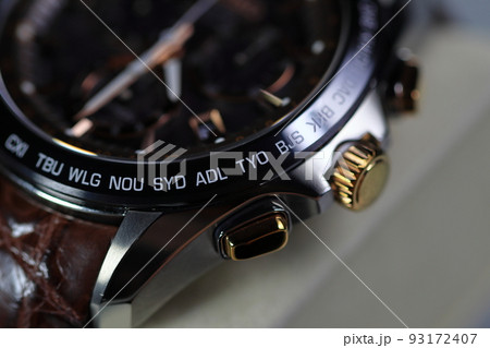 close up shallow focus Time zone cities code on luxury world time watch bezel, SYD Sydney, ADL Adelaide, NEU Neumea, TYO Tokyo. 93172407