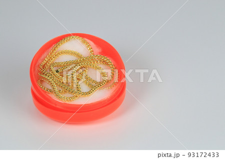 A keel pattern gold necklace in the chinese style red box isolated on white background. A keel pattern gold necklace in the chinese style red box isolated on white background. 93172433