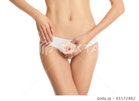 Woman with flower showing smooth skin after bikini epilation on white background, closeup 93172862