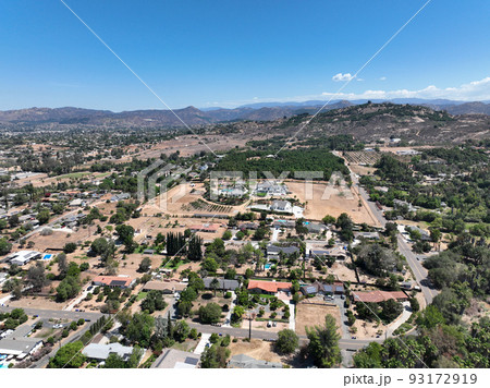 Aerial view of dry valley with houses and barn in Escondido, California 93172919
