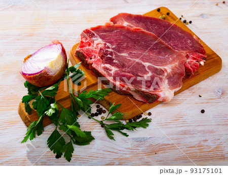 Raw pork chop on cutting board 93175101