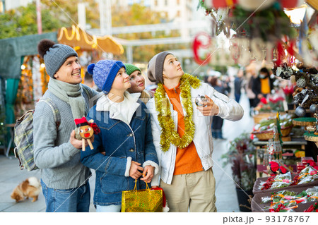 Family with two teenagers having fun on Christmas market  93178767