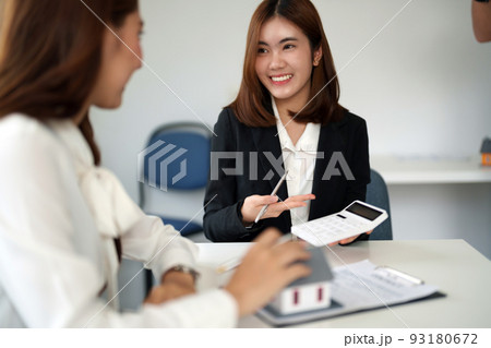 Real estate agent or bank officer describes the loan interest to the customer with home purchase contracts or on office loans and interest rates. 93180672