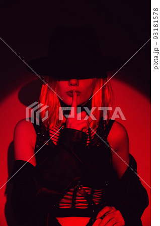 sexy fashion girl in a belt, leather raincoat and hat 93181578