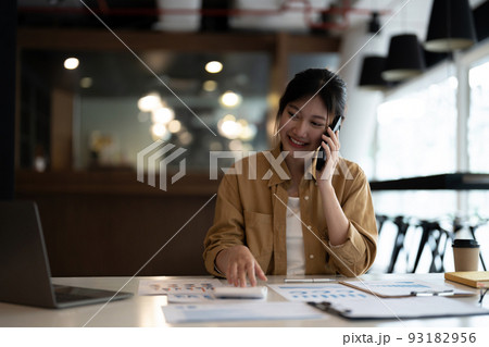 Business woman or accountant working audit while calling consultant her team. finance and accounting concept 93182956