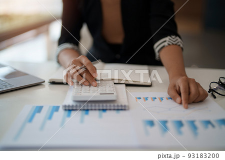 Businesswoman accountant or financial expert analyze business report graph and finance chart at corporate office. Concept of finance economy, banking business and stock market research. 93183200