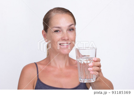 Woman of40s holding glass of pure water Woman of40s holding glass of pure water 93185369
