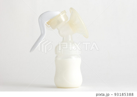 Isolated baby manual breast pump full of milk Isolated baby manual breast pump full of milk 93185388