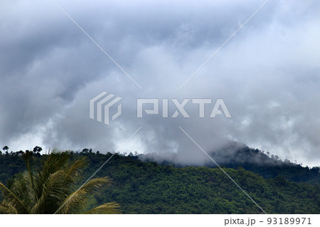 Dark storm cloud and fog descending on the mountain range 93189971