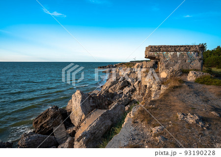 Ruins of bunkers on the beach of the Baltic sea, part of an old fort in the former Soviet base Karosta in Liepaja, Latvia. Sunset landscape. 93190228
