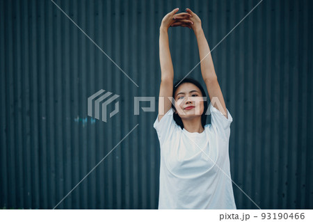 Asian young woman doing qigong yoga stretching pilates exercise summer outdoor. 93190466