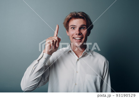Young man pointing and forefinger index finger up Young man pointing and forefinger index finger up 93190529