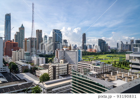 Aerial view of Bangkok cityscape in the morning showing high-rises with a golf course and cloudy blue sky 93190831