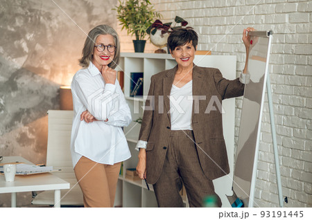 Two businesswomen in the office working on the project Two businesswomen in the office working on the project 93191445