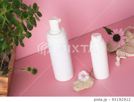 White bottle with a cosmetic products and flowers with natural materials White bottle with a cosmetic products and flowers with natural materials 93192912