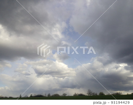 Light from heaven, blue planet Earth in white clouds, bright sunlight from above. 93194429