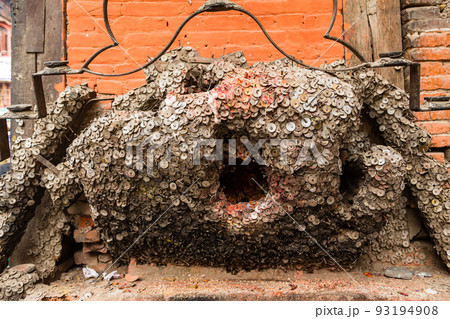 ネパール　カトマンズにある歯痛を治す神様が祀られていと言われているコインが釘付けされたコインの木 93194908