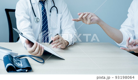 The doctor hand write report and explained the health examination results to the patient, medical checkup concept 93198064