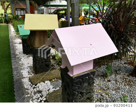 SERDANG, MALAYSIA -JUNE 7, 2022: Heterotrigona Itama or known as Stingless Bee. Man-made nests made of wood and colored colorfully to look attractive. it is farmed to get its honey. 93200413