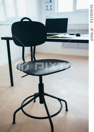 Empty work space chair, desk with laptop Empty work space chair, desk with laptop 93200640