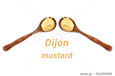 Two spoons with mustard on a white background between them the inscription Dijon mustard. Two spoons with mustard on a white background between them the inscription Dijon mustard. 93200906