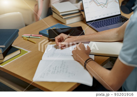 Close up of student sitting in university library and prepare for exam 93201916