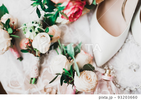 Beautiful toned picture with wedding rings against the background of a bouquet of flowers Beautiful toned picture with wedding rings against the background of a bouquet of flowers 93203660