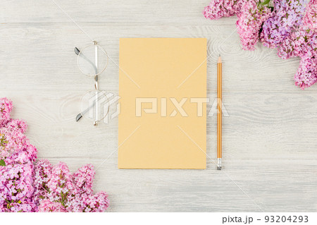 Craft sketchbook with pencil and lilac flowers 93204293